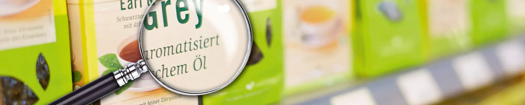 Tea packs on a shelf with a magnifying glass